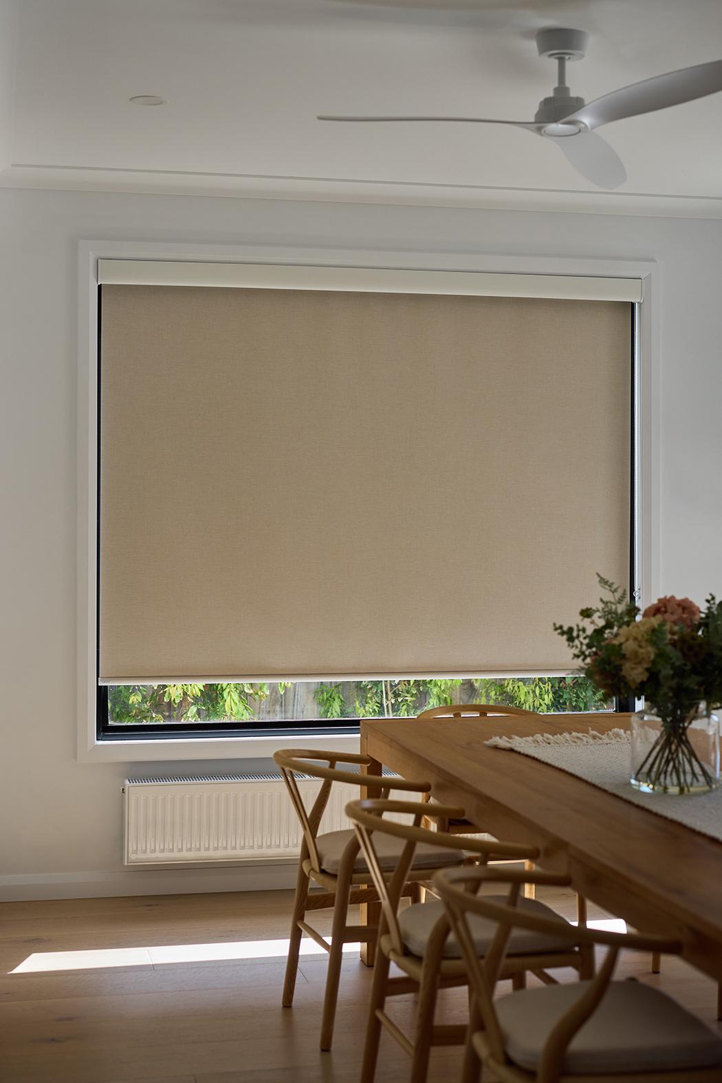 An open-plan living and dining room with a wide glazed corner covered to the floor