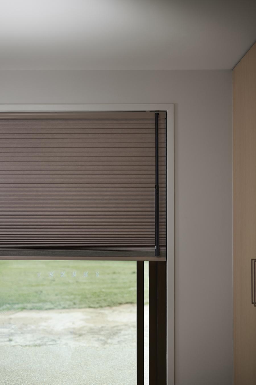 A roller shade headrail at the top of a window