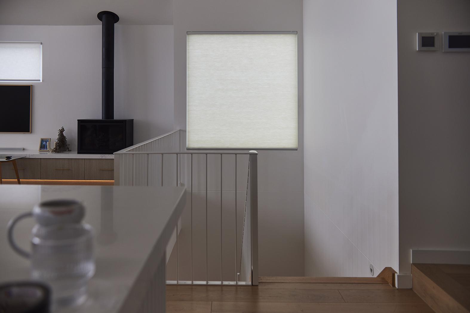 White honeycomb shades in a kitchen. 